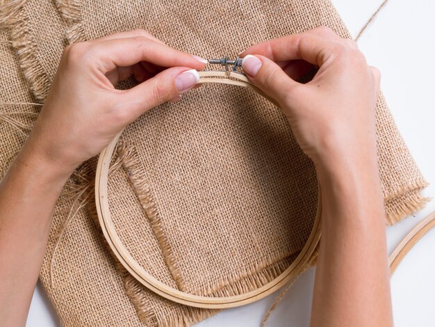 Woman making decorations out of wood rings