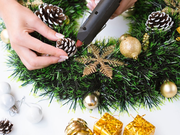 Woman making decorations with pine cones