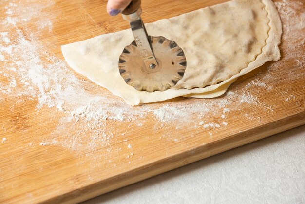 Woman making gutab on wooden board. Azerbaijan national cuisine. 