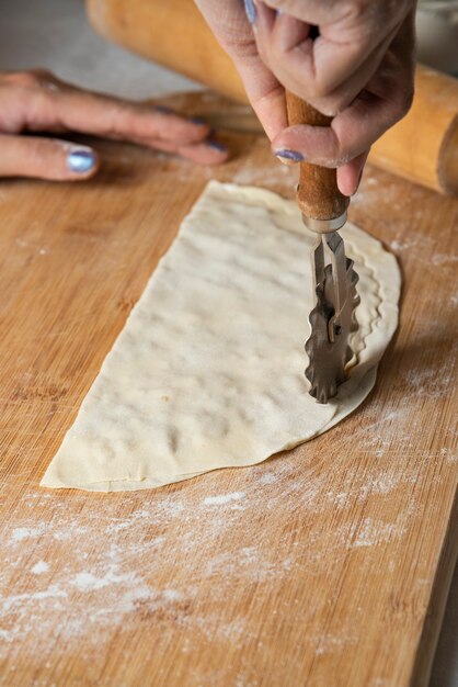 Woman making gutab on wooden board. Azerbaijan national cuisine. 