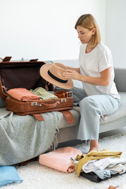 Woman making her baggage for the next vacation