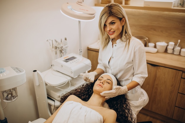 Woman making injections at cosmetologist