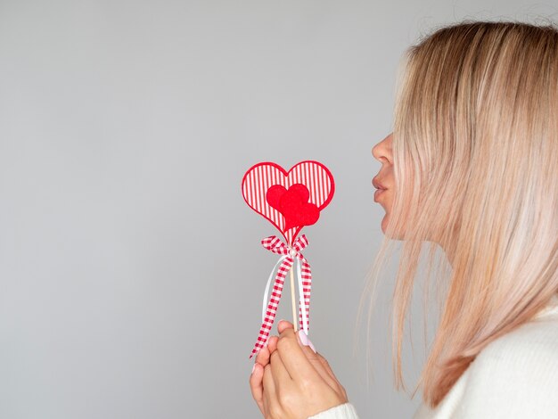 Woman making kissing gesture copy space