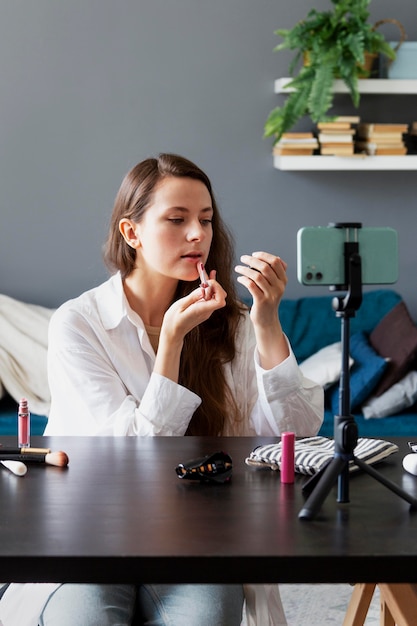 Woman making a makeup vlog with her smartphone