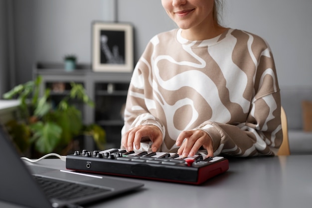 Free photo woman making music on couch close up