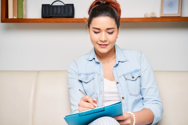 Woman making notes in document