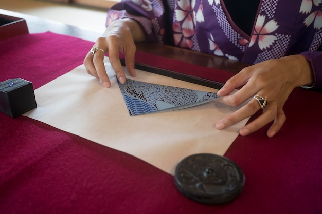 Free photo woman making origami with japanese paper