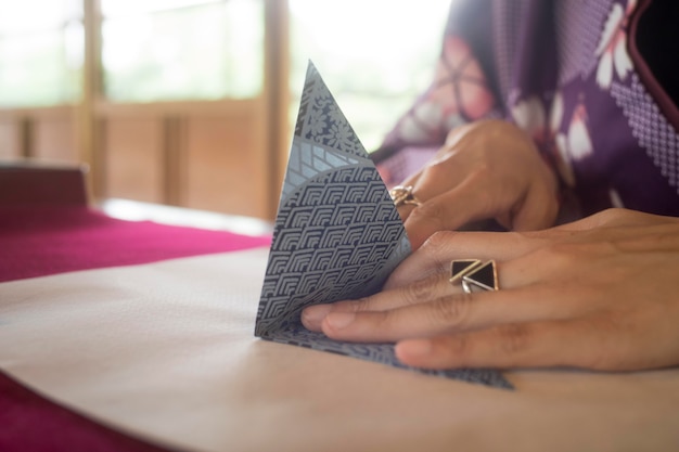 Woman making origami with japanese paper