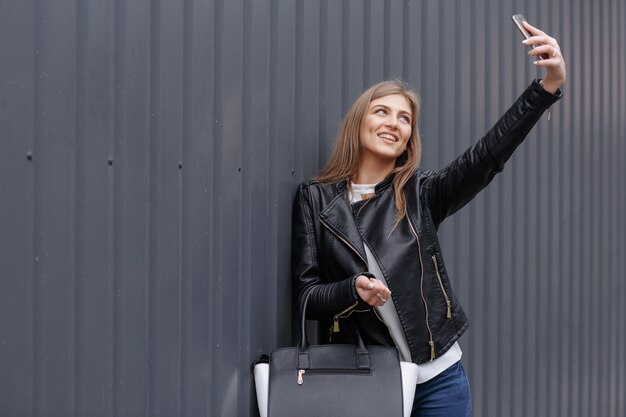 Woman making a photo of herself smiling