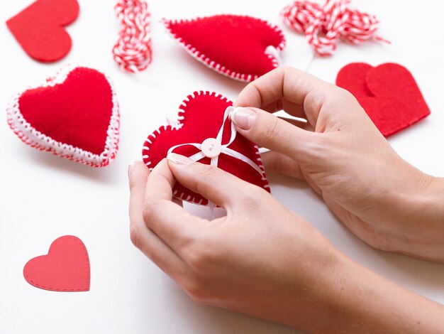 Woman making red hearts decorations