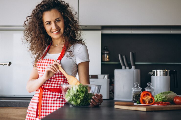 Free Photo woman making salad at the kitchen