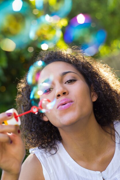 Woman making soap bubbles