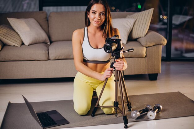Woman making video of workout at home