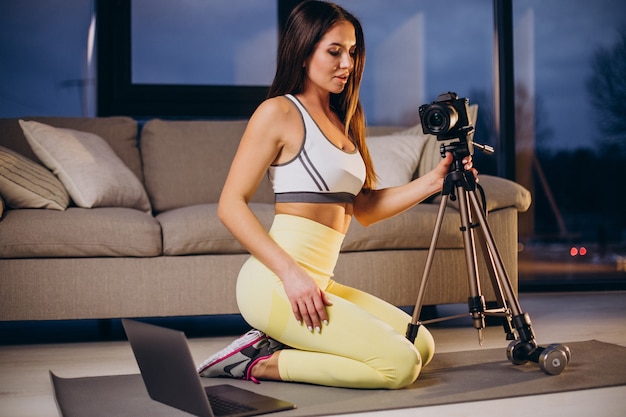Woman making video of workout at home