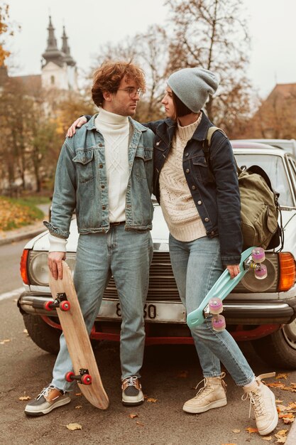 Woman and man holding their skateboards