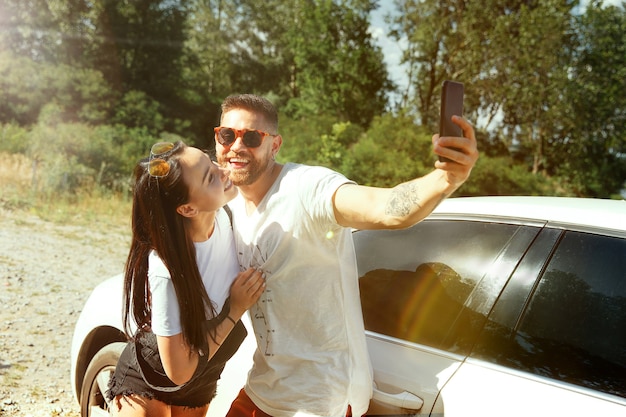 Woman and man making selfie in the forest and looks happy. concept of relationship.