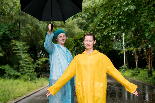 Woman and man posing in rain