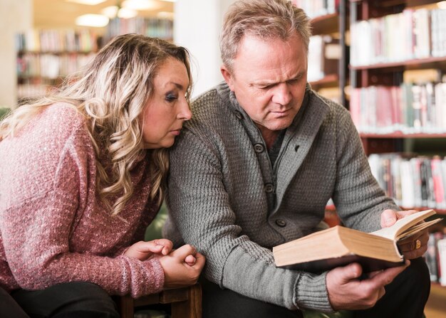 Woman and man reading a book