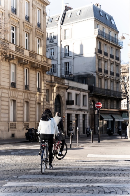 Woman and man riding bikes in the city in france