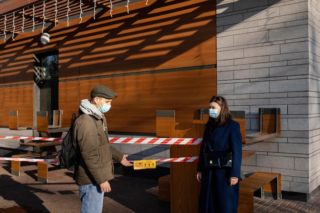 Woman and man on street wearing mask