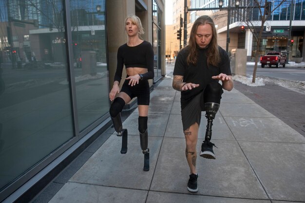 Woman and man with leg disability exercising in the city