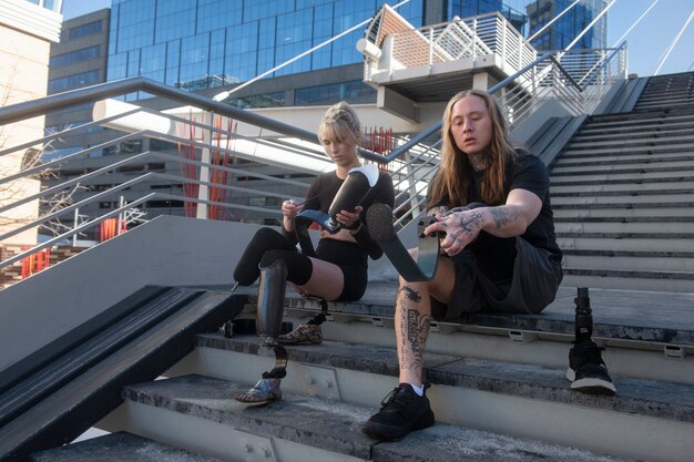 Woman and man with leg disability preparing to go running in the city