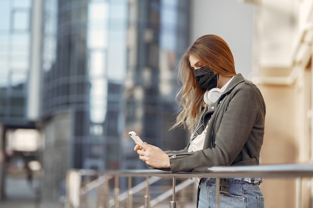 Woman in a mask stands on the street