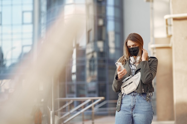 Woman in a mask stands on the street