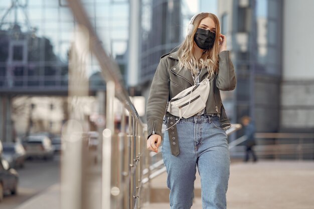 Woman in a mask stands on the street