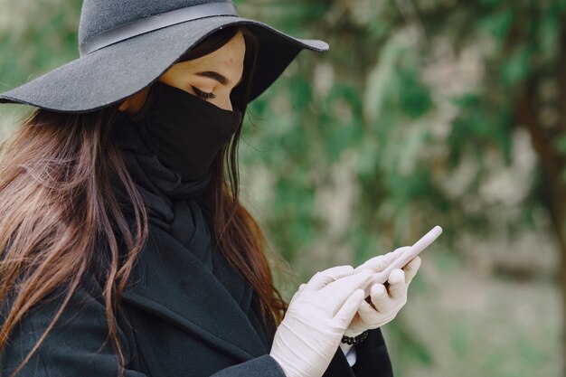 Woman in a mask stands on the street