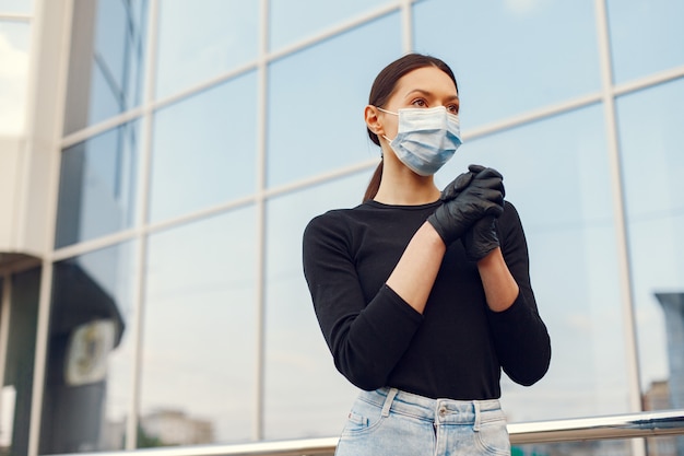 Woman in a mask stands on the street