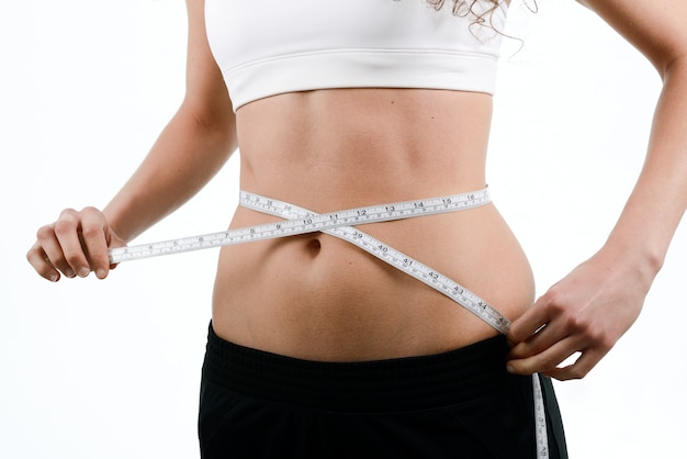 Woman measuring her waist