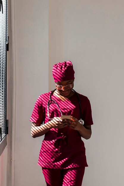 Woman medic looking at her phone