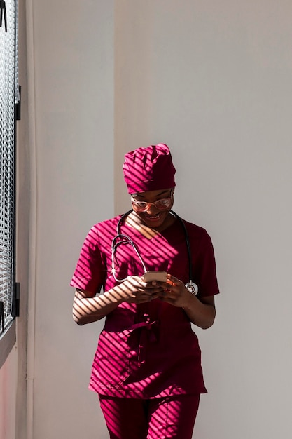 woman medic looking at her phone