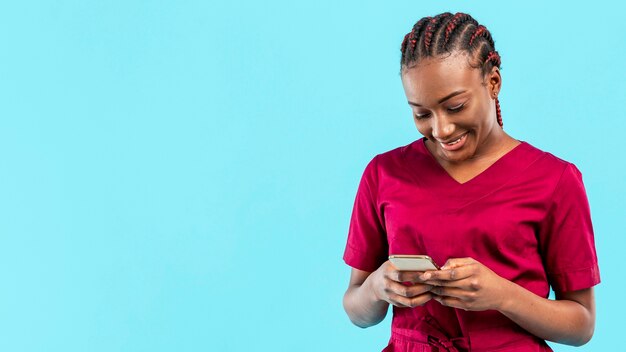 Woman medic looking at her phone