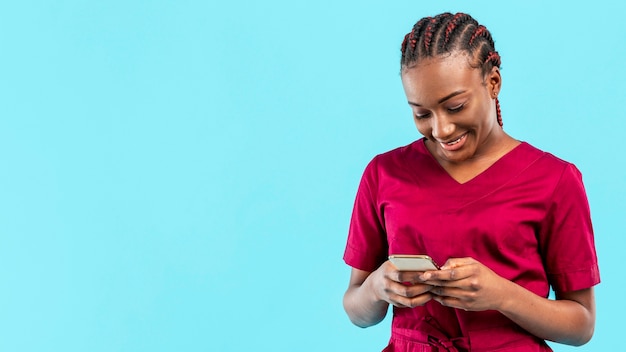 woman medic looking at her phone