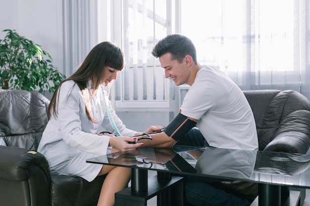 Woman medic measuring pulse of patient