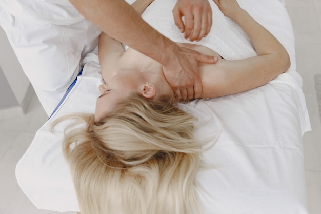 Free photo woman in the medical office. physiotherapist is rehabilitating back.