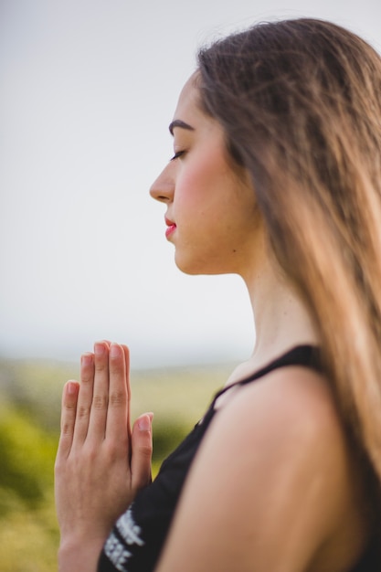 Free photo woman meditating in field