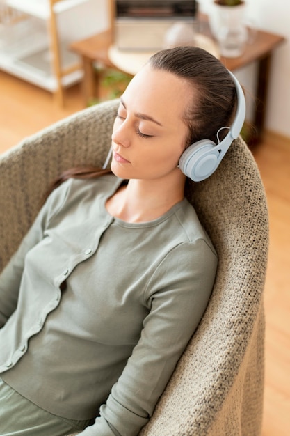 Woman meditating at home on chair