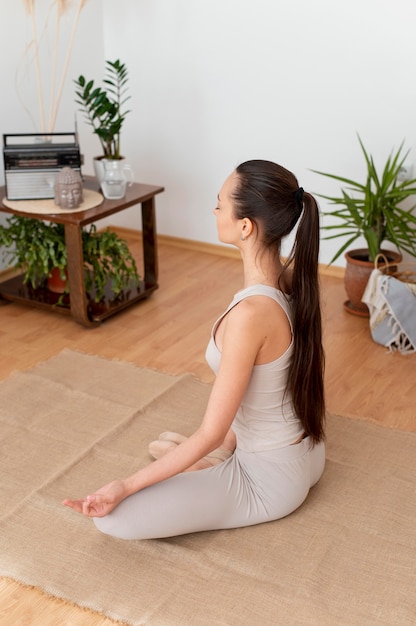 Free photo woman meditating at home