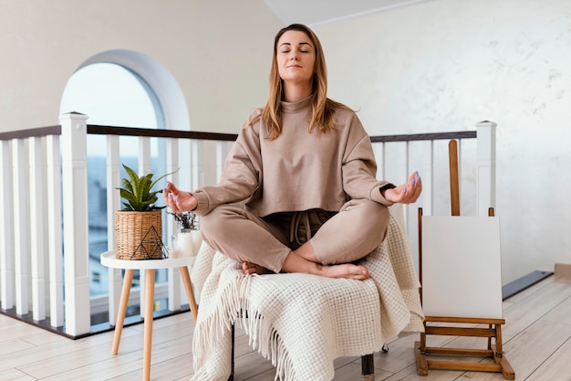 Free photo woman meditating indoor