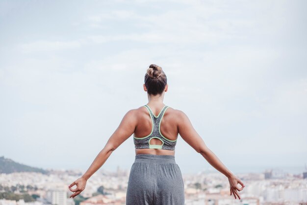 Woman meditating looking towards city