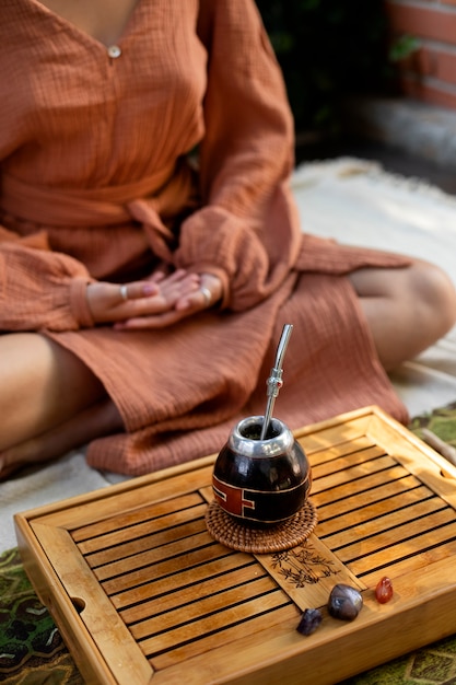 Free photo woman meditating outdoors high angle