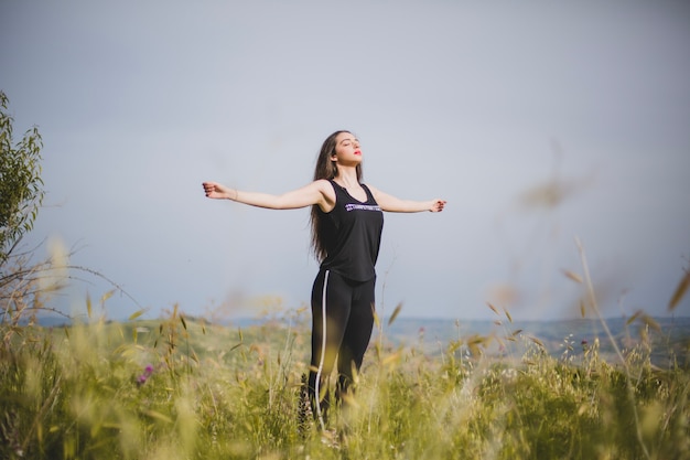 Woman meditating with hands apart