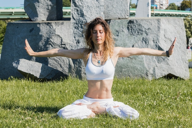 Woman meditating with hands apart