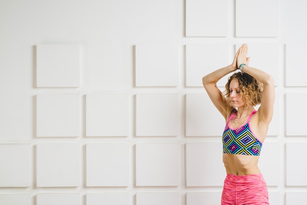 Free photo woman meditating with hands over head