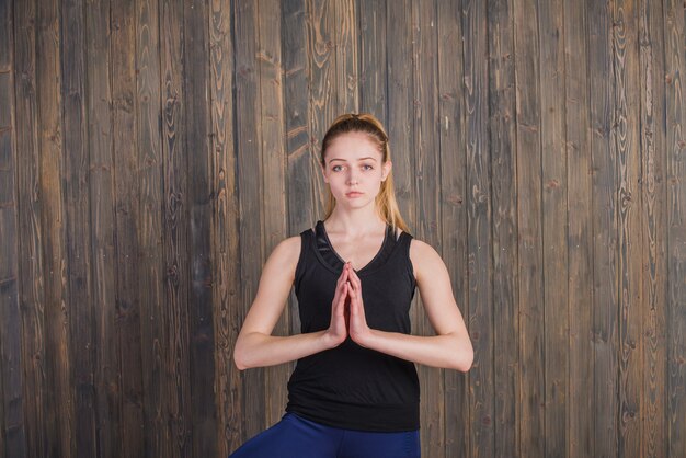 Woman meditating on wooden background