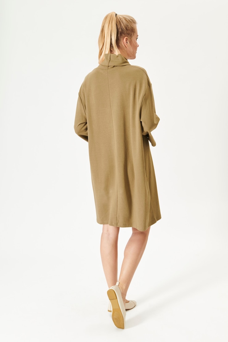 Free Photo woman in a minimal beige dress mockup