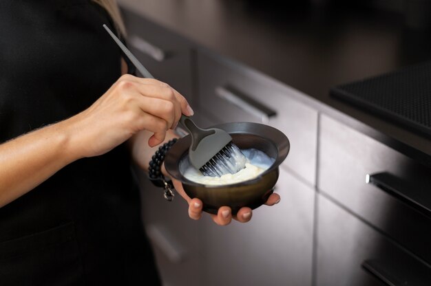 Woman mixing hair dye in a bowl